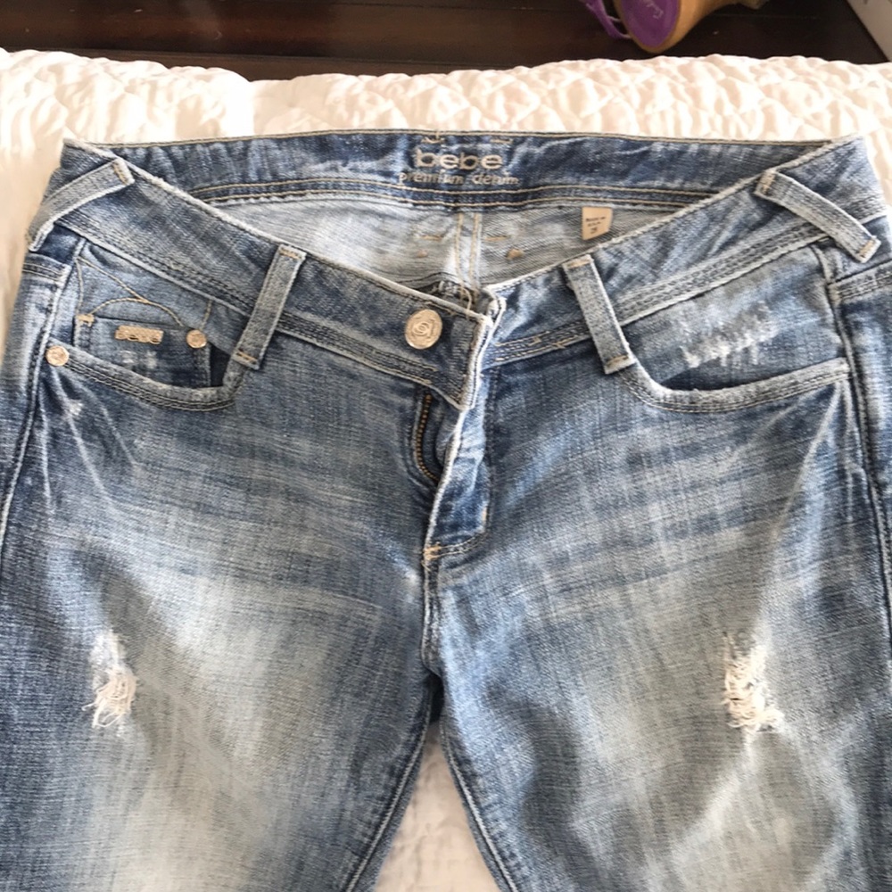 Bebe premium denim flared bottoms with rips.